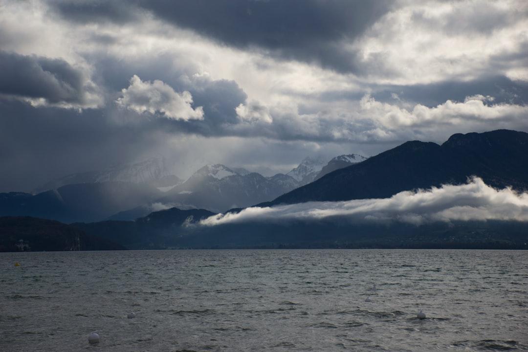 Dramatic clouds over the mountains behind Lake Annecy