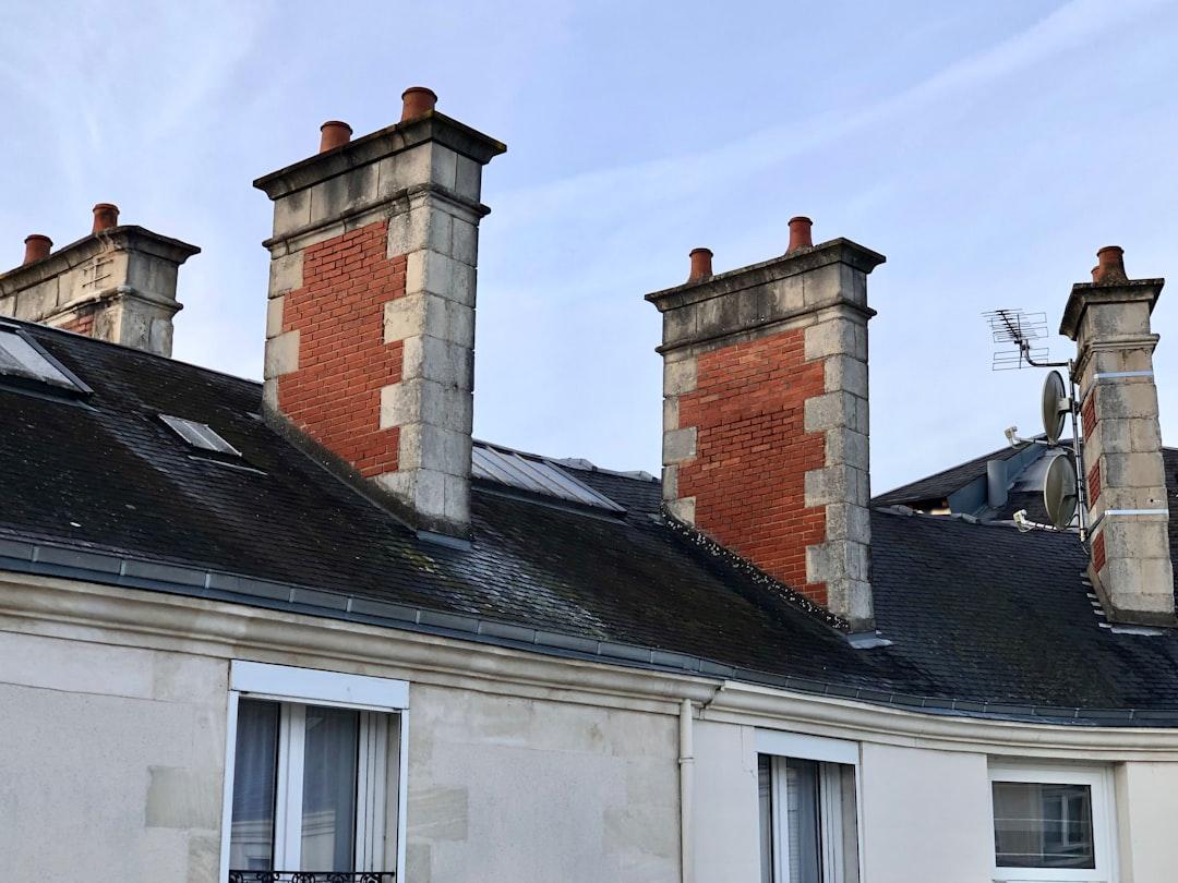 Red brick chimneys on an old rooftop