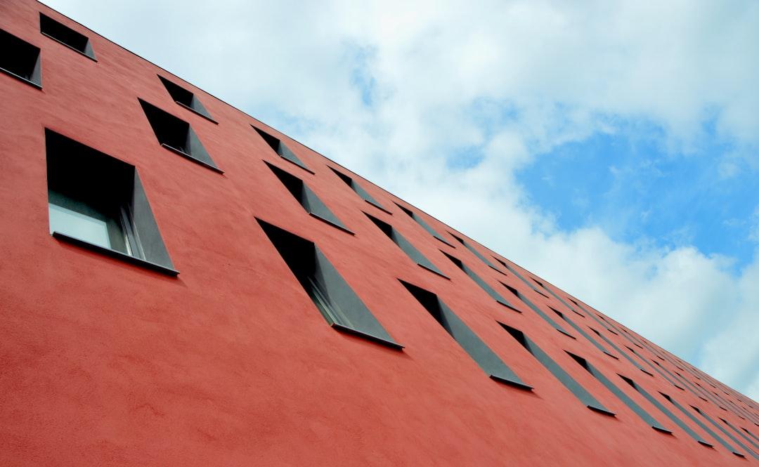 A pleasing contrast between the red wall of a building and a bright sky. 